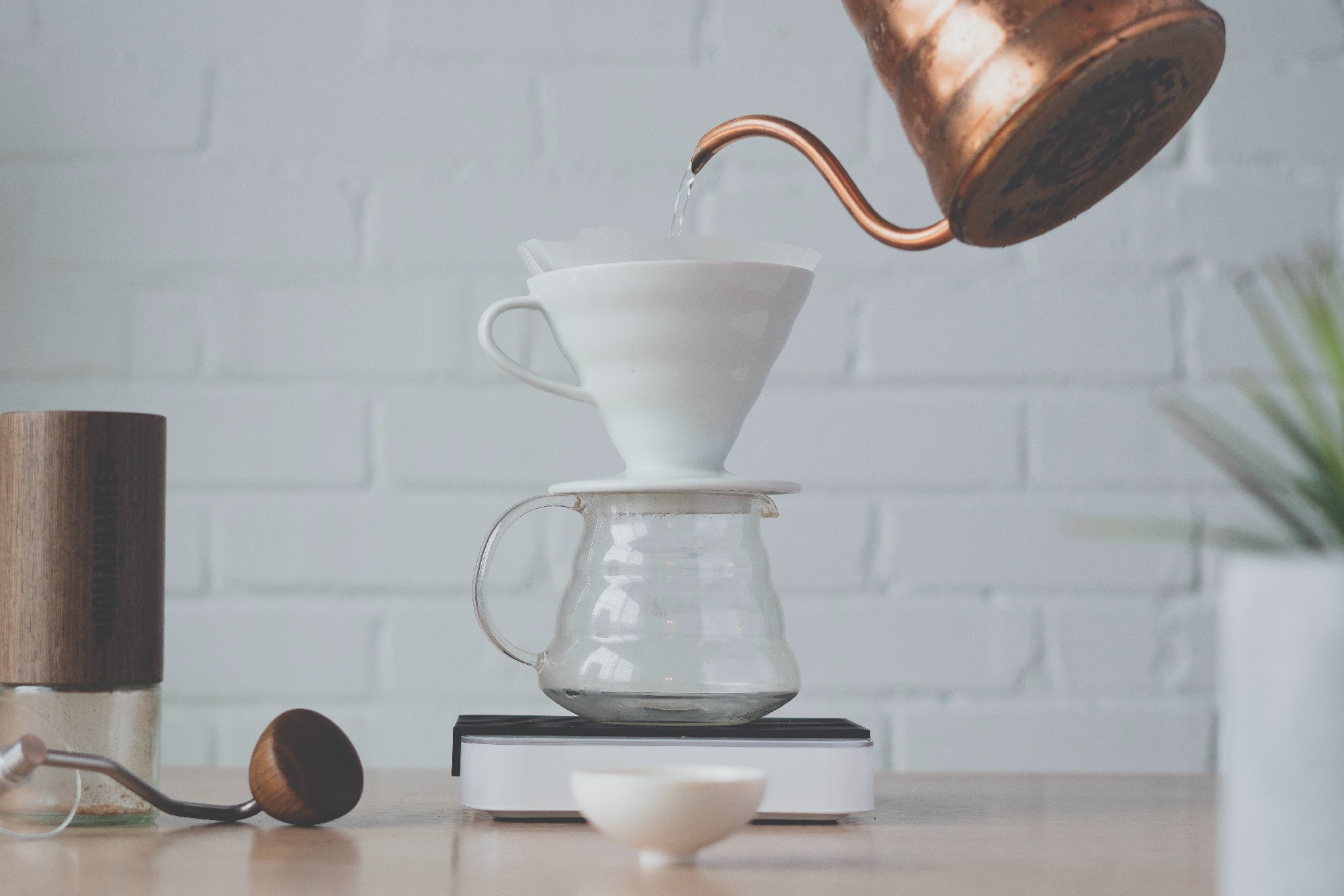 Hario pot and v60 drip cone with a pot pouring water.